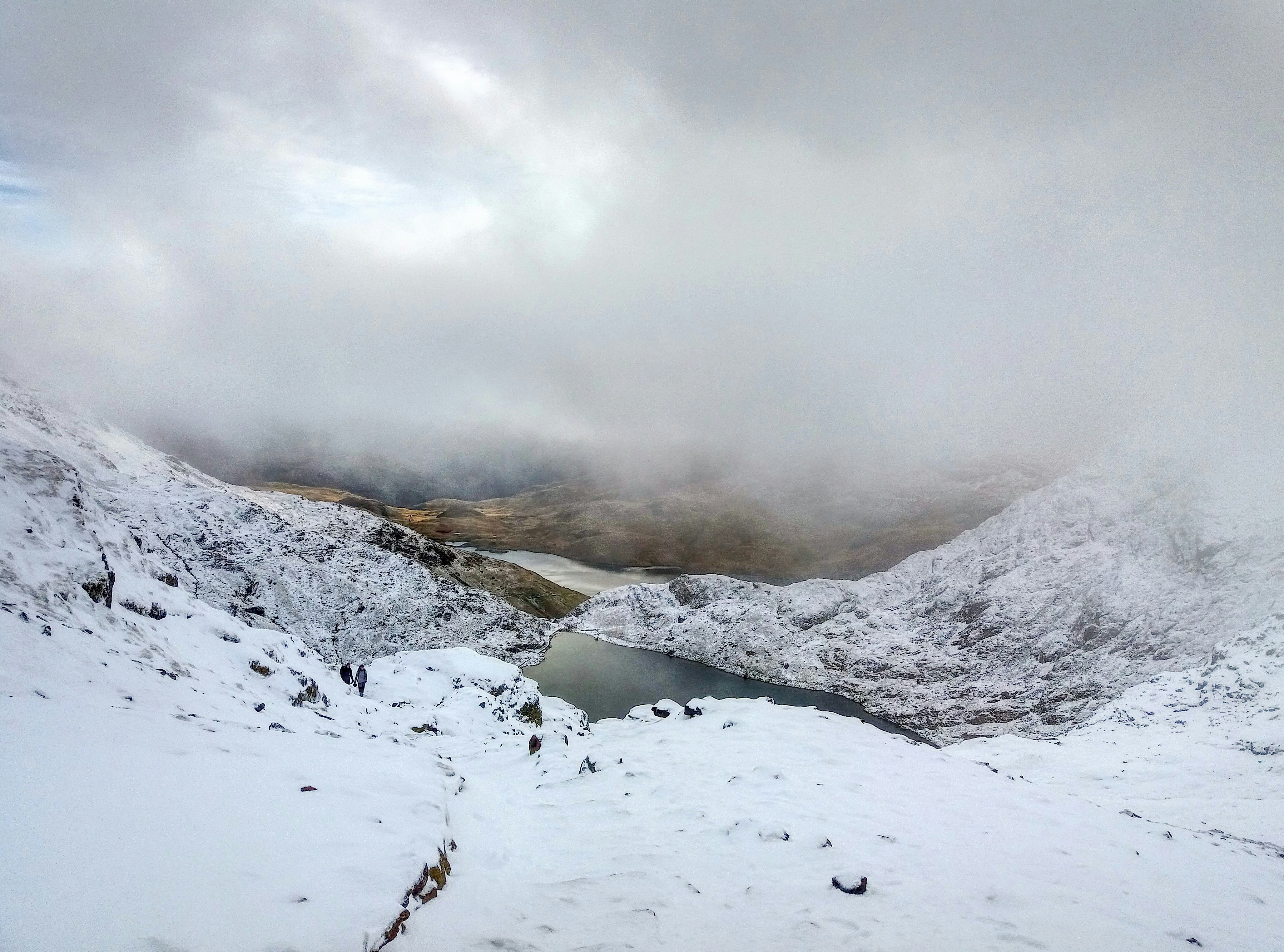 snow mountain landscape with body of water and fog during daytime